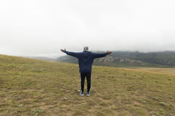 Black man standing in the mountains
