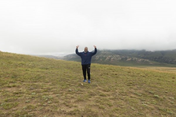 Black man standing in the mountains