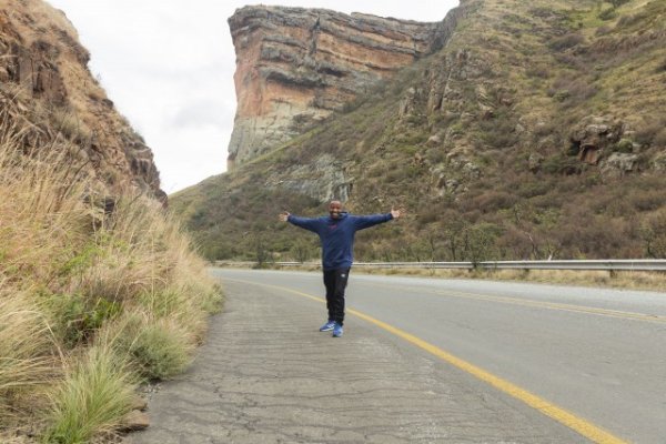 Black man standing in the mountains