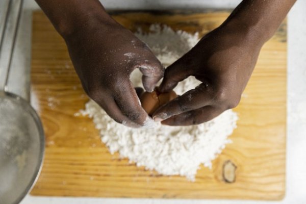 Cracking  an egg inside flour for baking