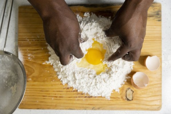 Mixing eggs inside flour