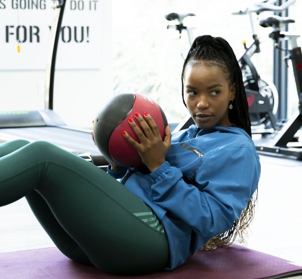 At the gym doing exercise ball moves