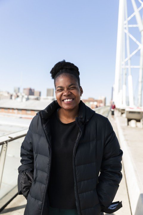 Black woman smiling on nelson Mandela bridge
