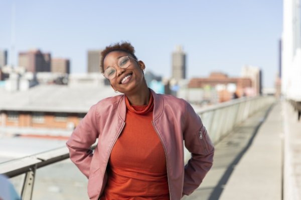 Black woman on Nelson Mandela bridge grinning
