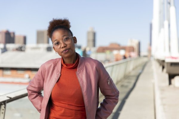 Black woman on Nelson Mandela bridge looking at camera