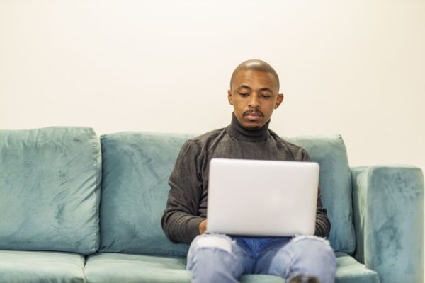 Black man working on his laptop at home