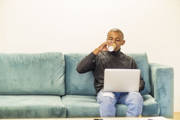 Black man working on his laptop at home