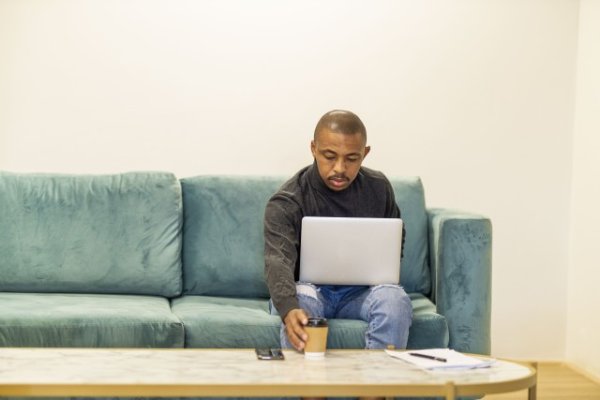 Black man working on his laptop at home