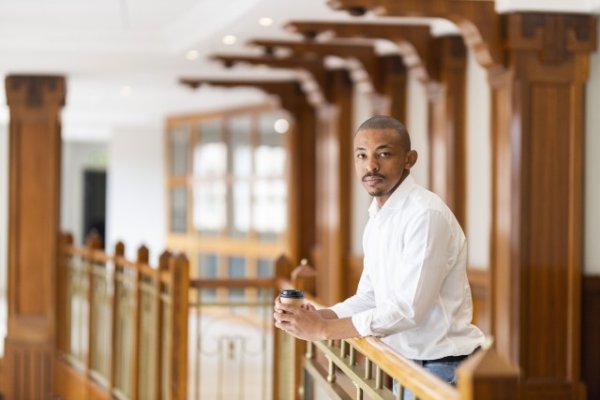 Black business man at work holding coffee