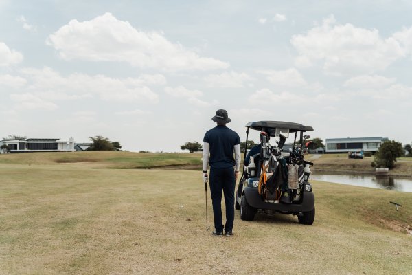 Black male golfer looking at the green to take the perfect shot