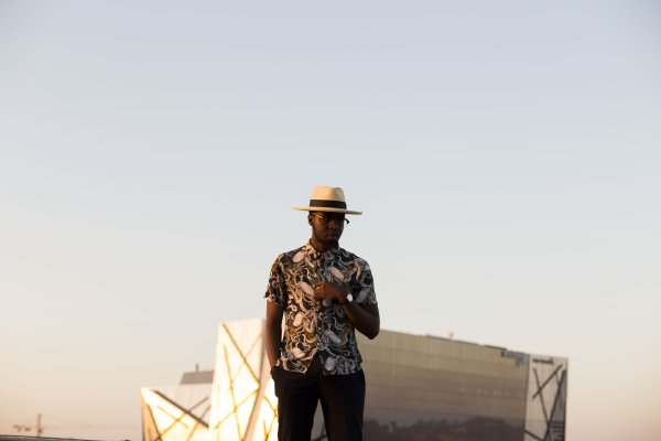 Black man posing on a rooftop