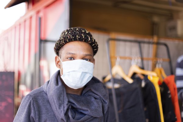 Black man wearing mask with beanie