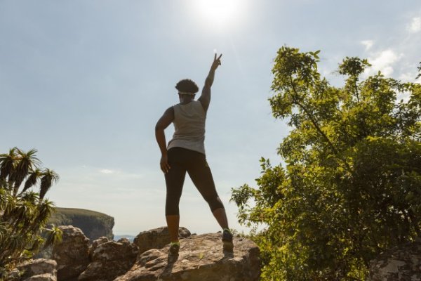 Black woman climbing rocks in Mpumalanga