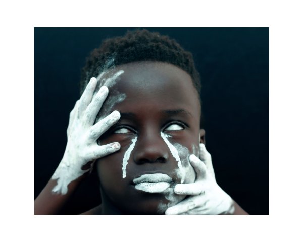 Young black man covered in white ash