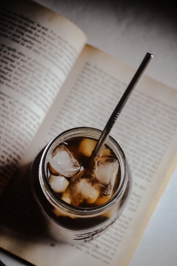 Iced coffee on top of a reading book