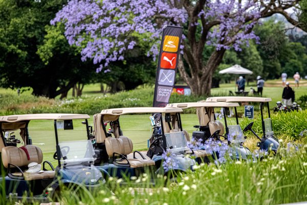 Golf carts parked in line at a golf club in South Africa during a tournament