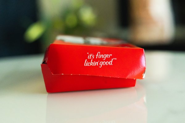 It's finger licking' good slogan on a KFC meal box.