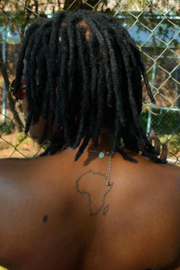 Mama Africa tattoo on a black skinned woman