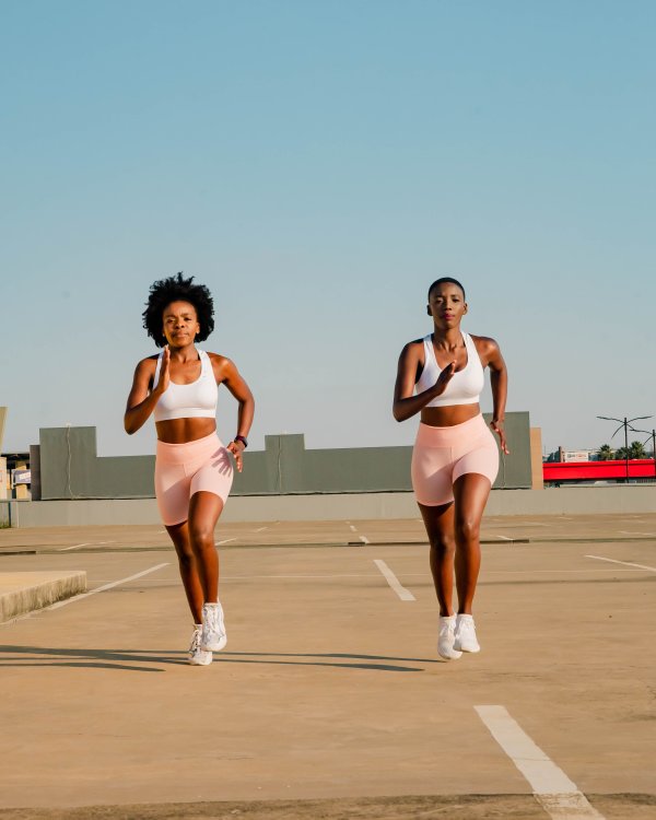 Two black women running on a rooftop
