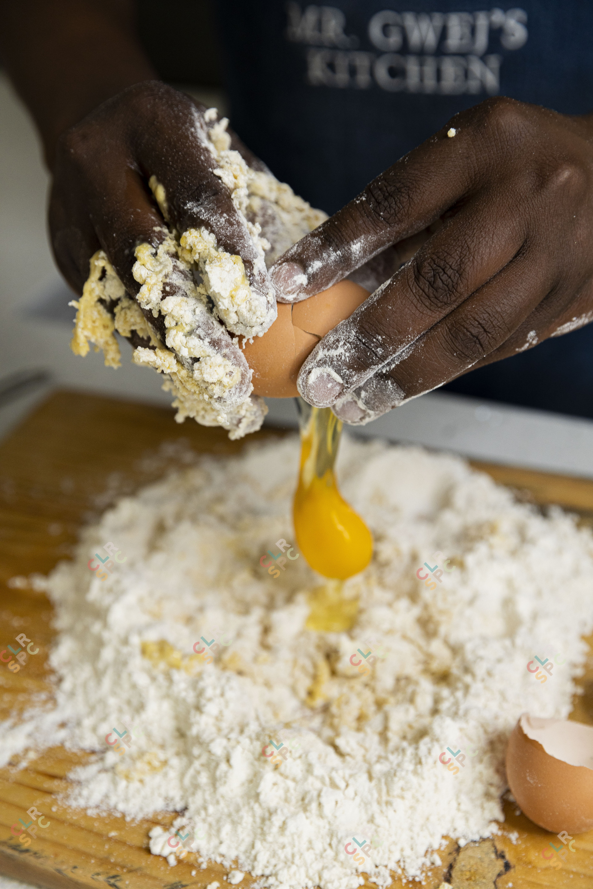Cracking  eggs inside flour for baking