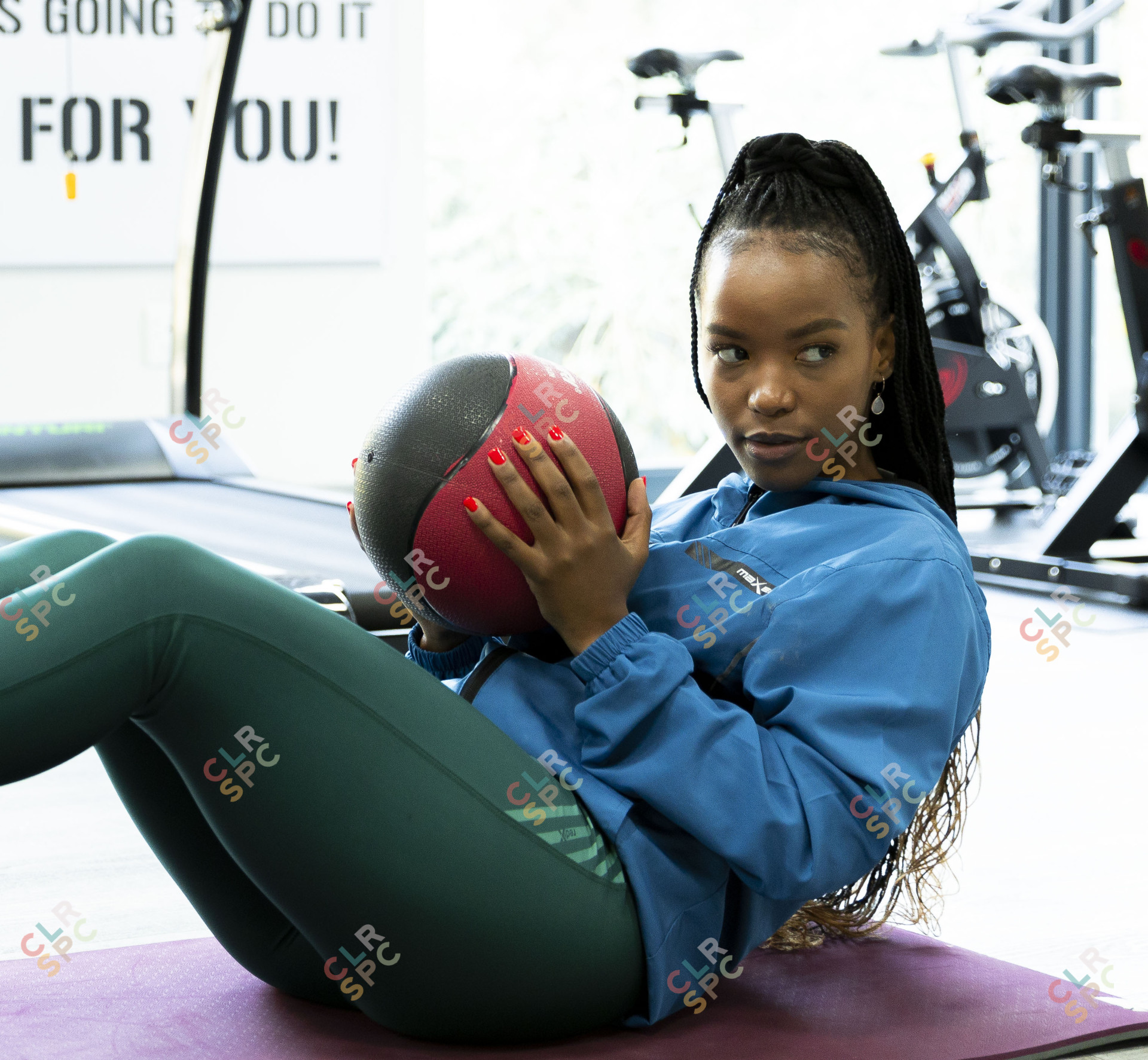 At the gym doing exercise ball moves