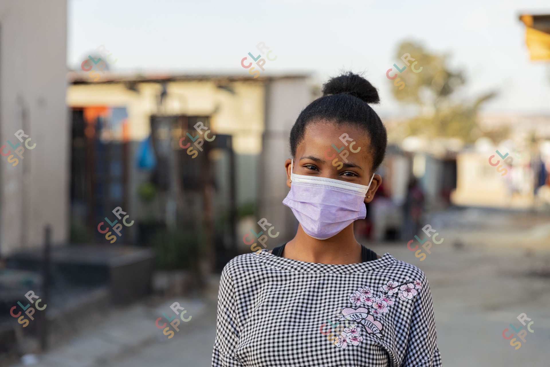 Young black woman wearing mask ekasi