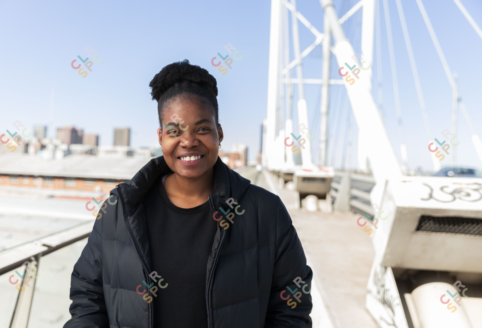 Black woman wearing all black smiling