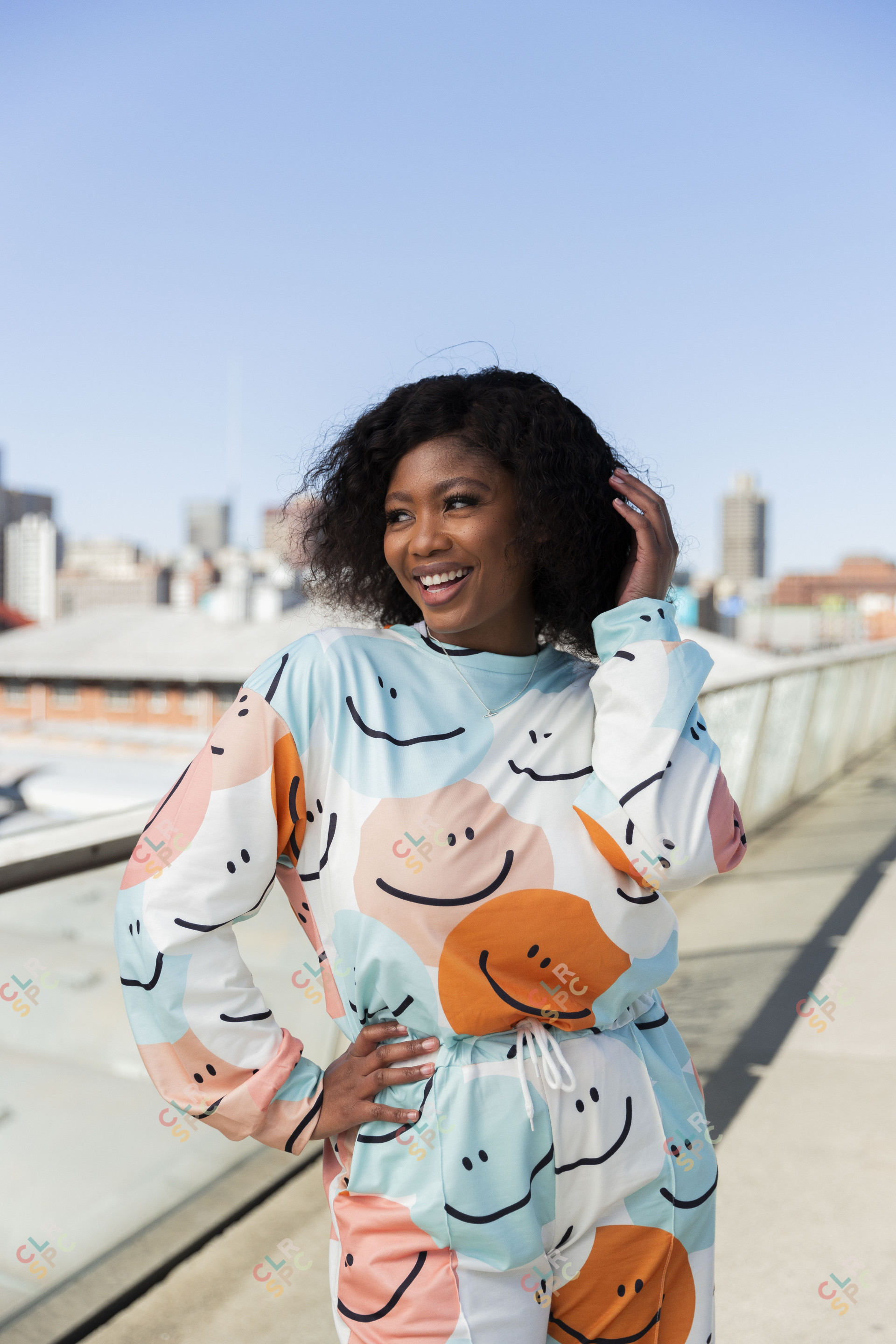 Black woman on Nelson Mandela bridge smiling with colourful clothing