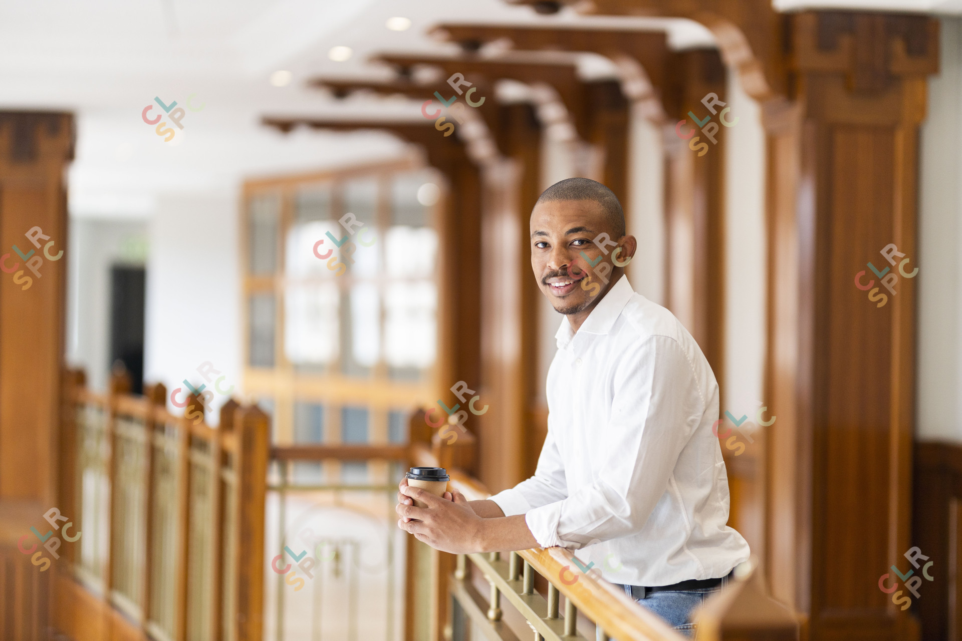 Black business man at work holding coffee