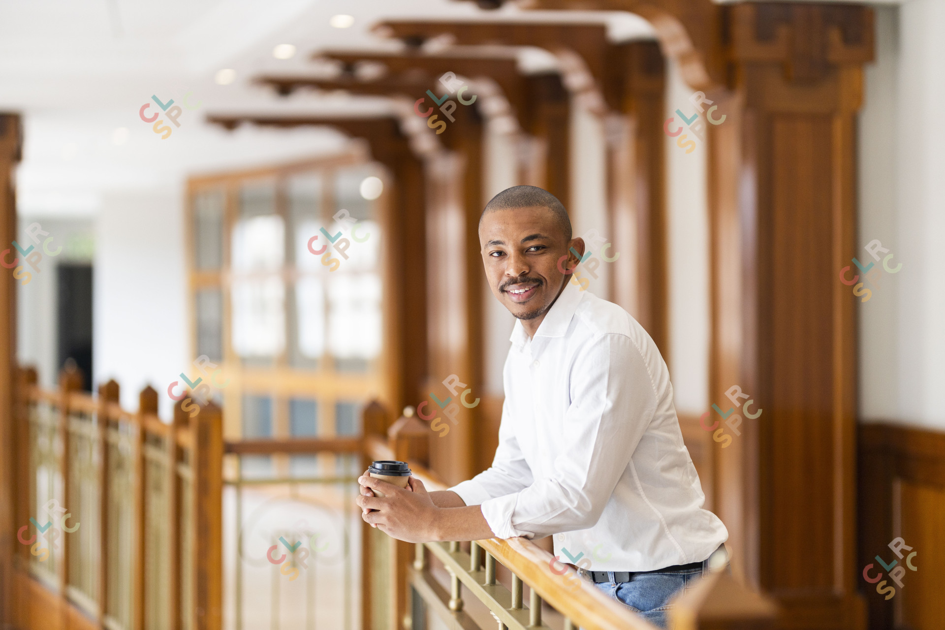 Black business man at work holding coffee