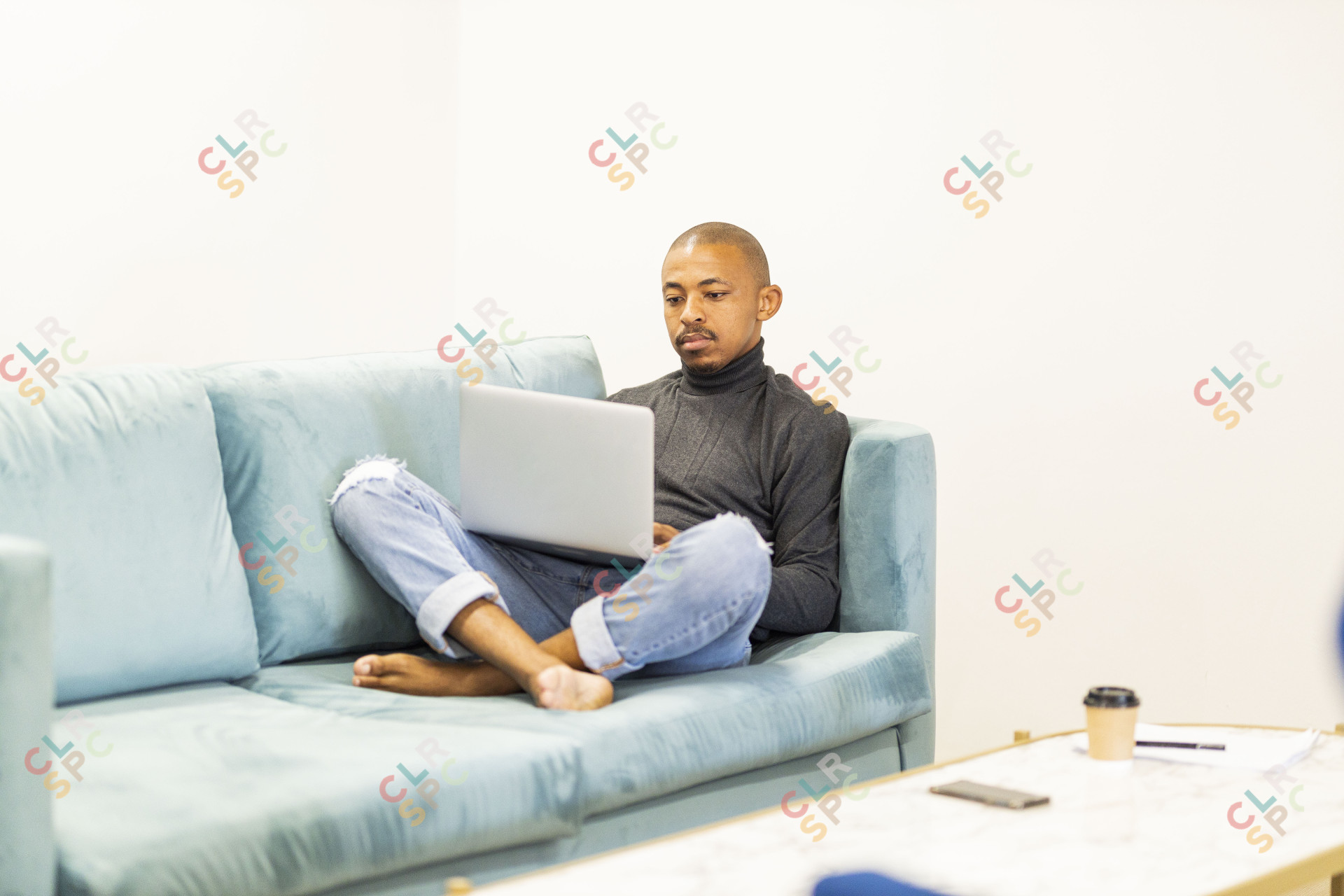 Black man working on his laptop at home