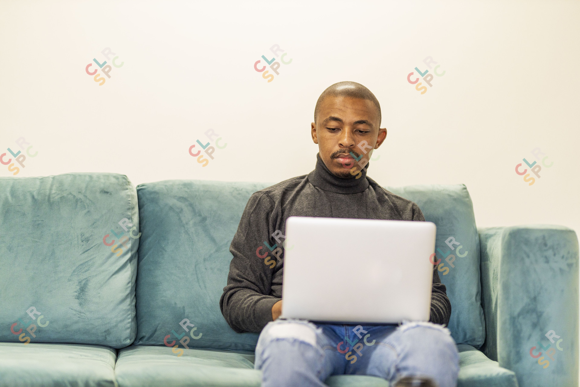 Black man working on his laptop at home