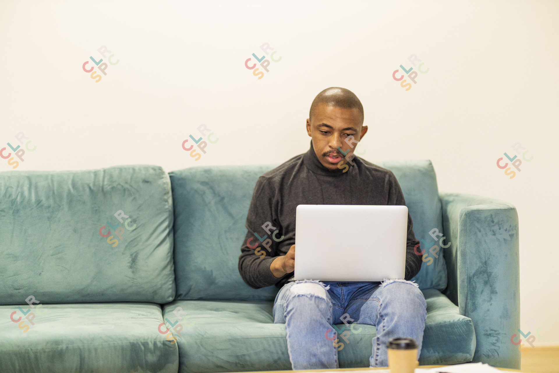 Black man working on his laptop at home