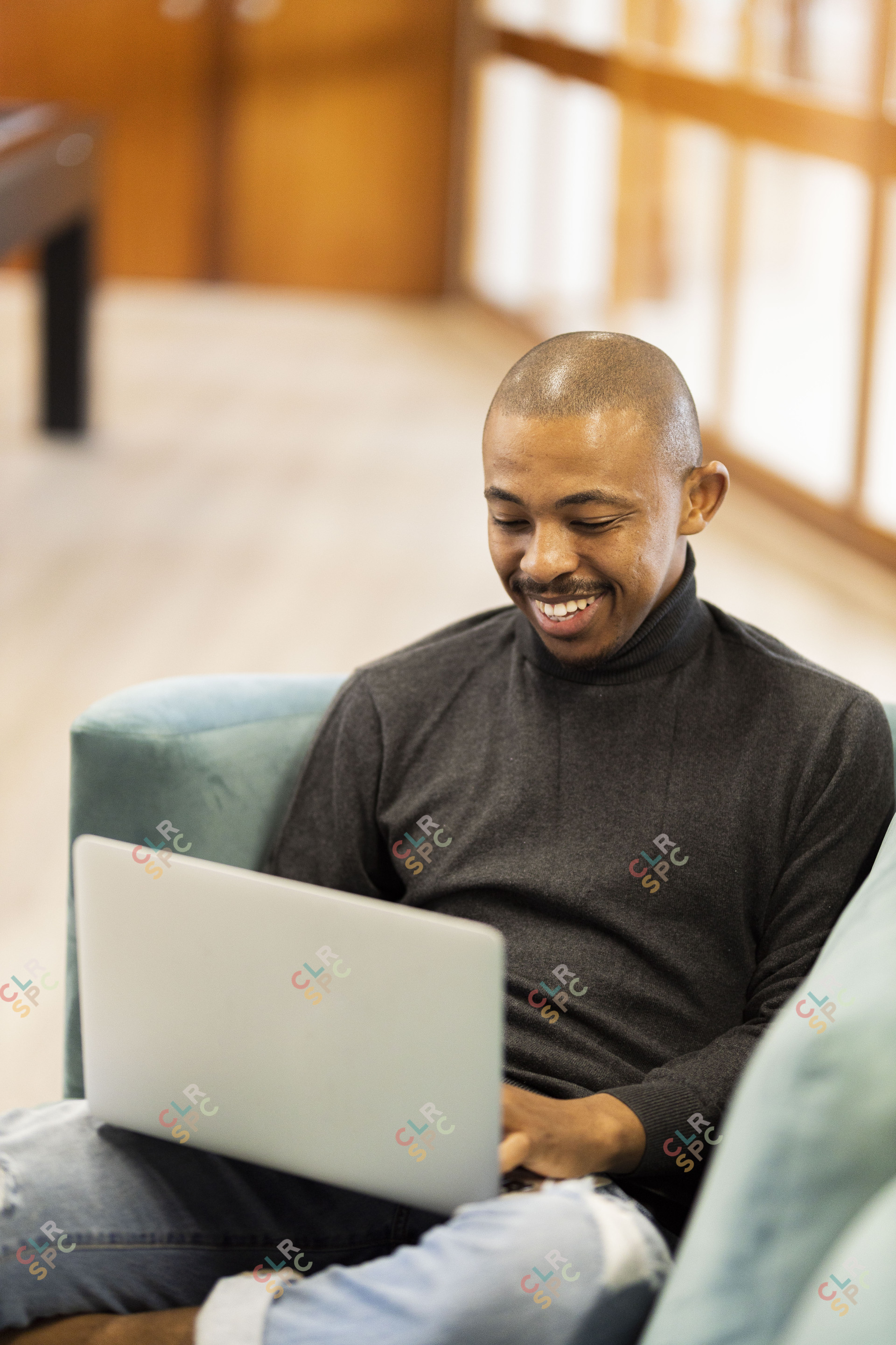 Black man working on his laptop at home