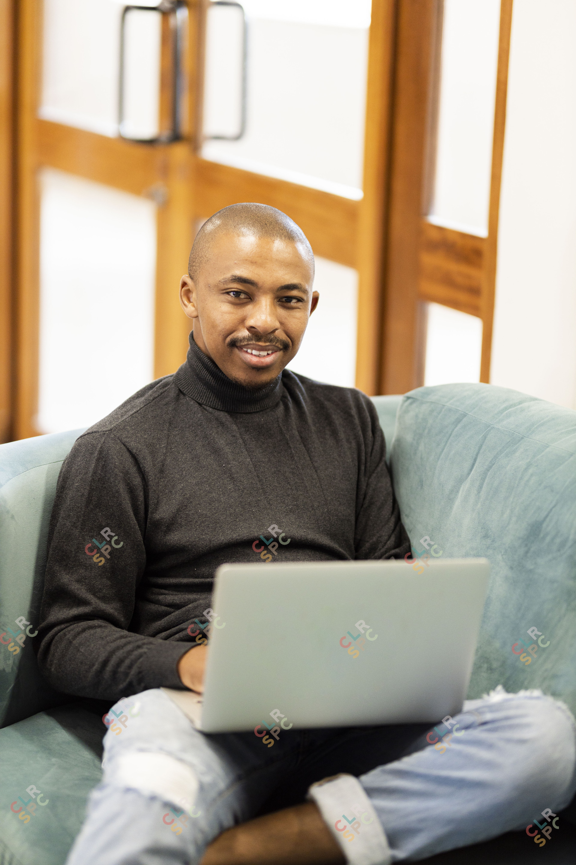 Black man working on his laptop at home