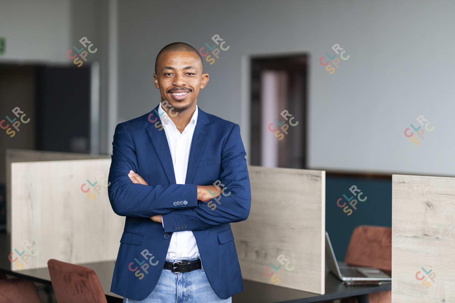 Black business man smiling from his desk at the office