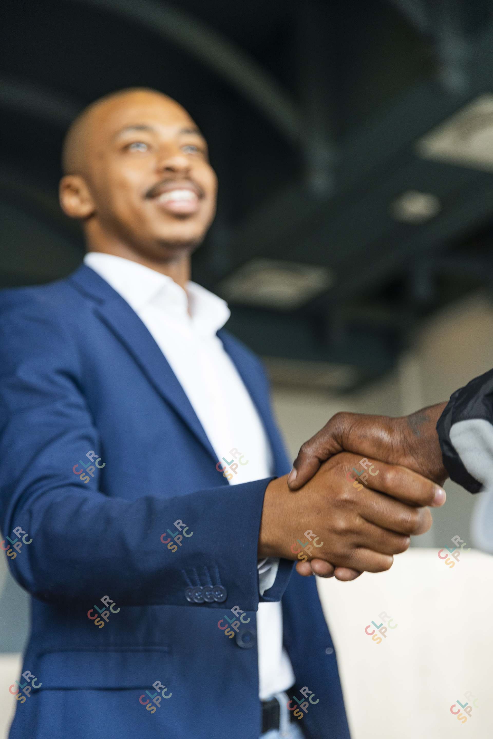 Black business man hand shaking a client at the office
