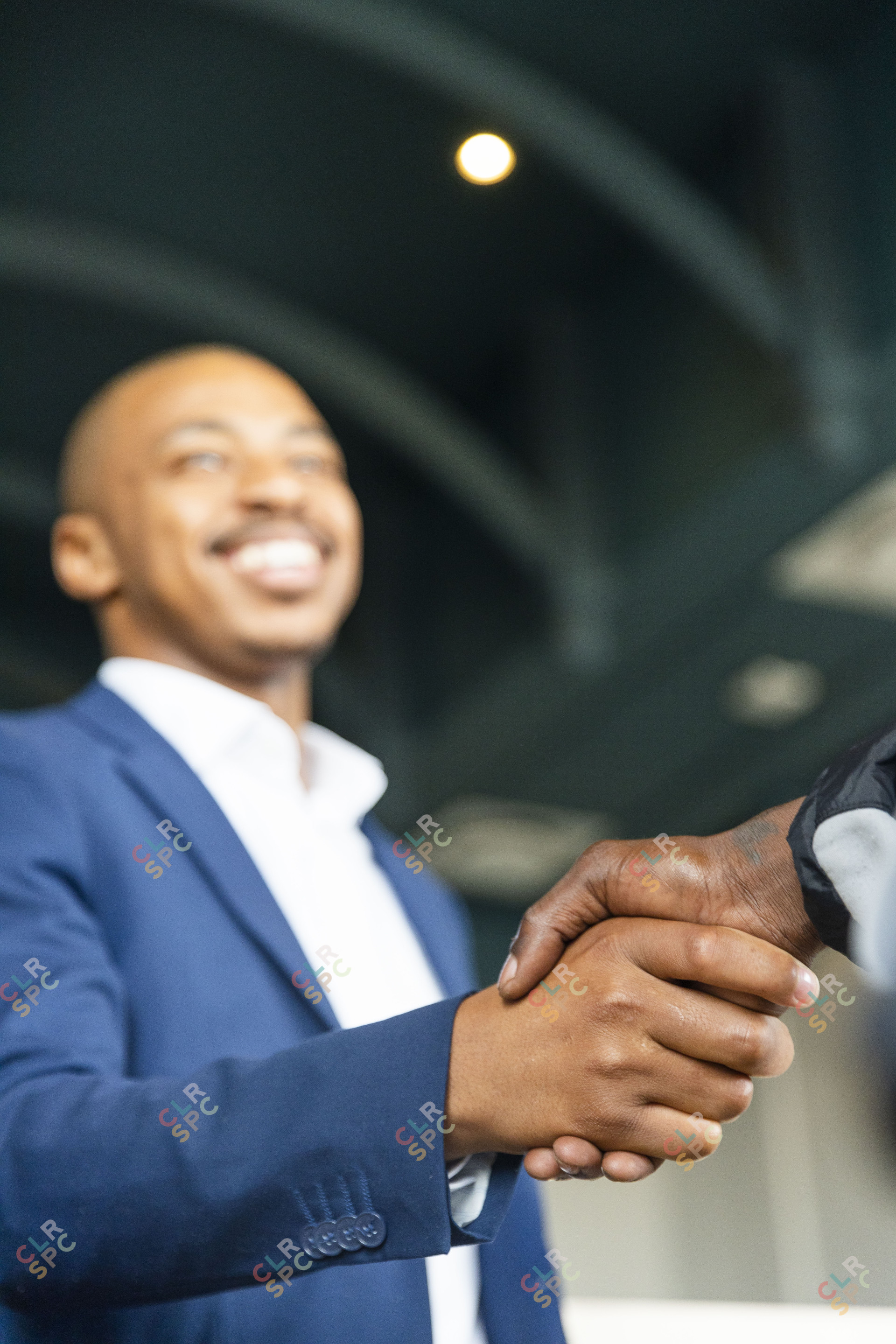 Black business man hand shaking hands with a client at the office