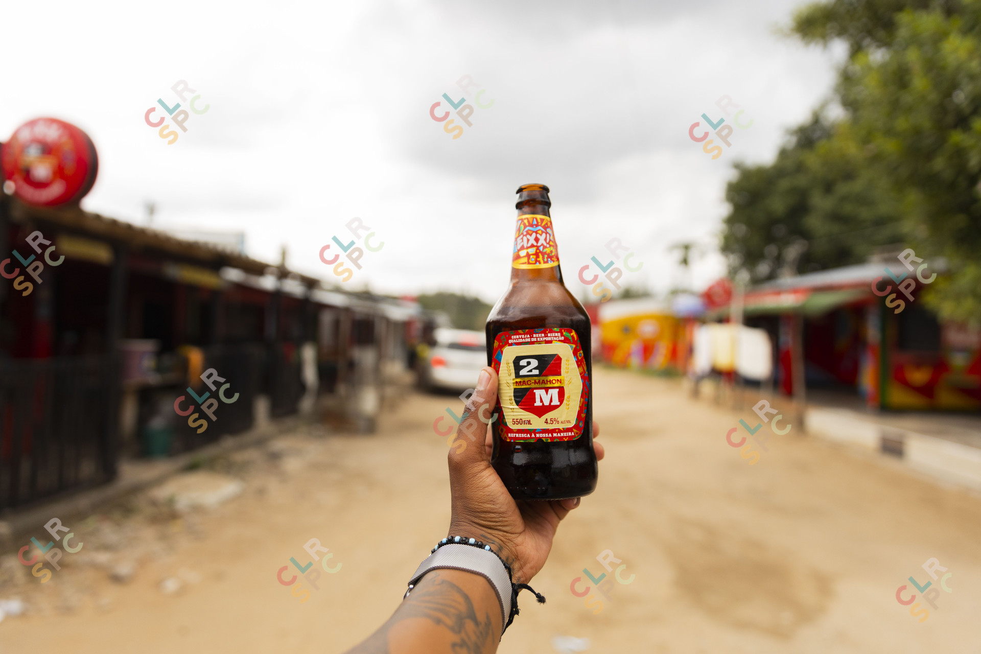 Black hand holding Mozambique beer.