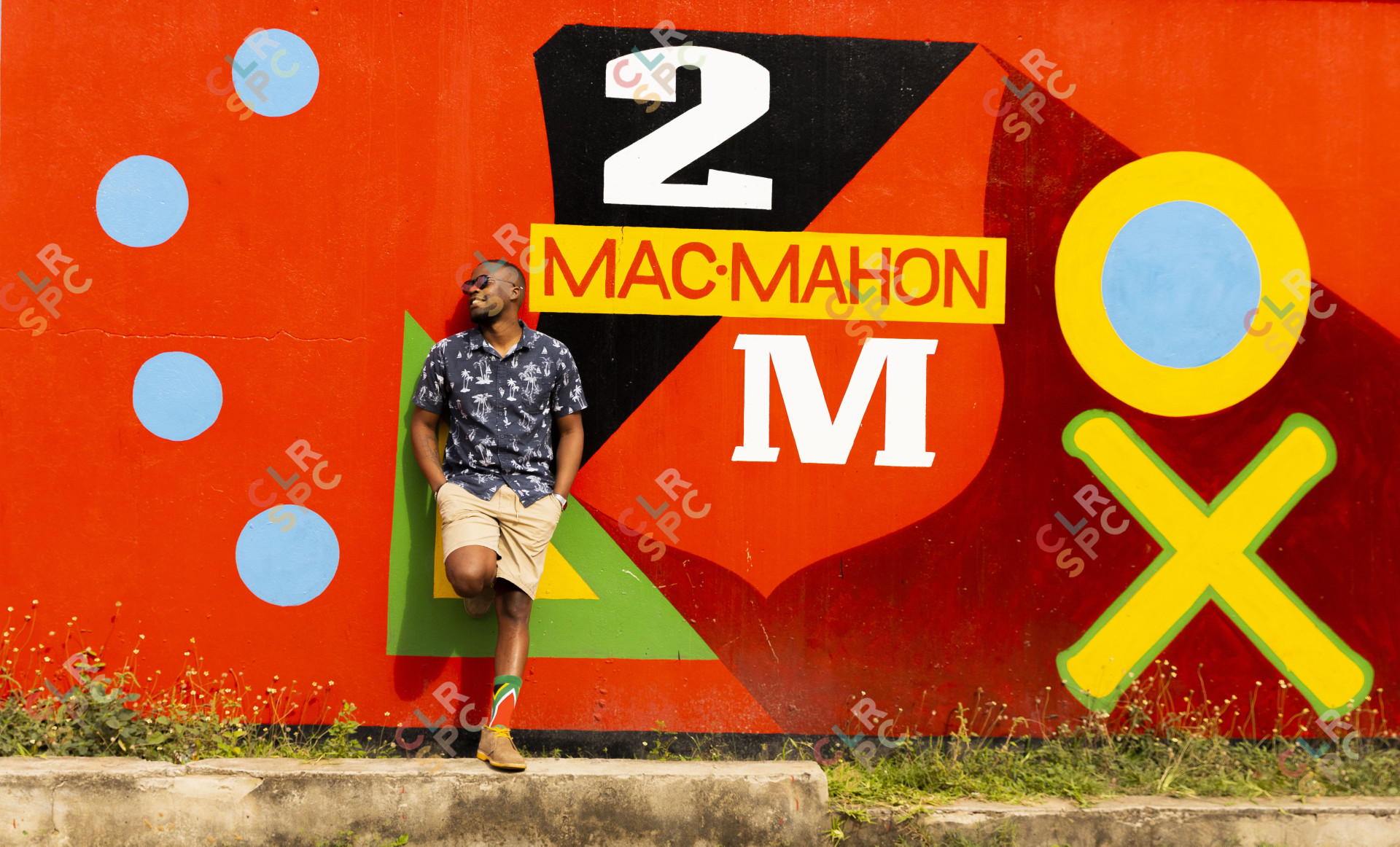Black man near a 2M beer advert board.