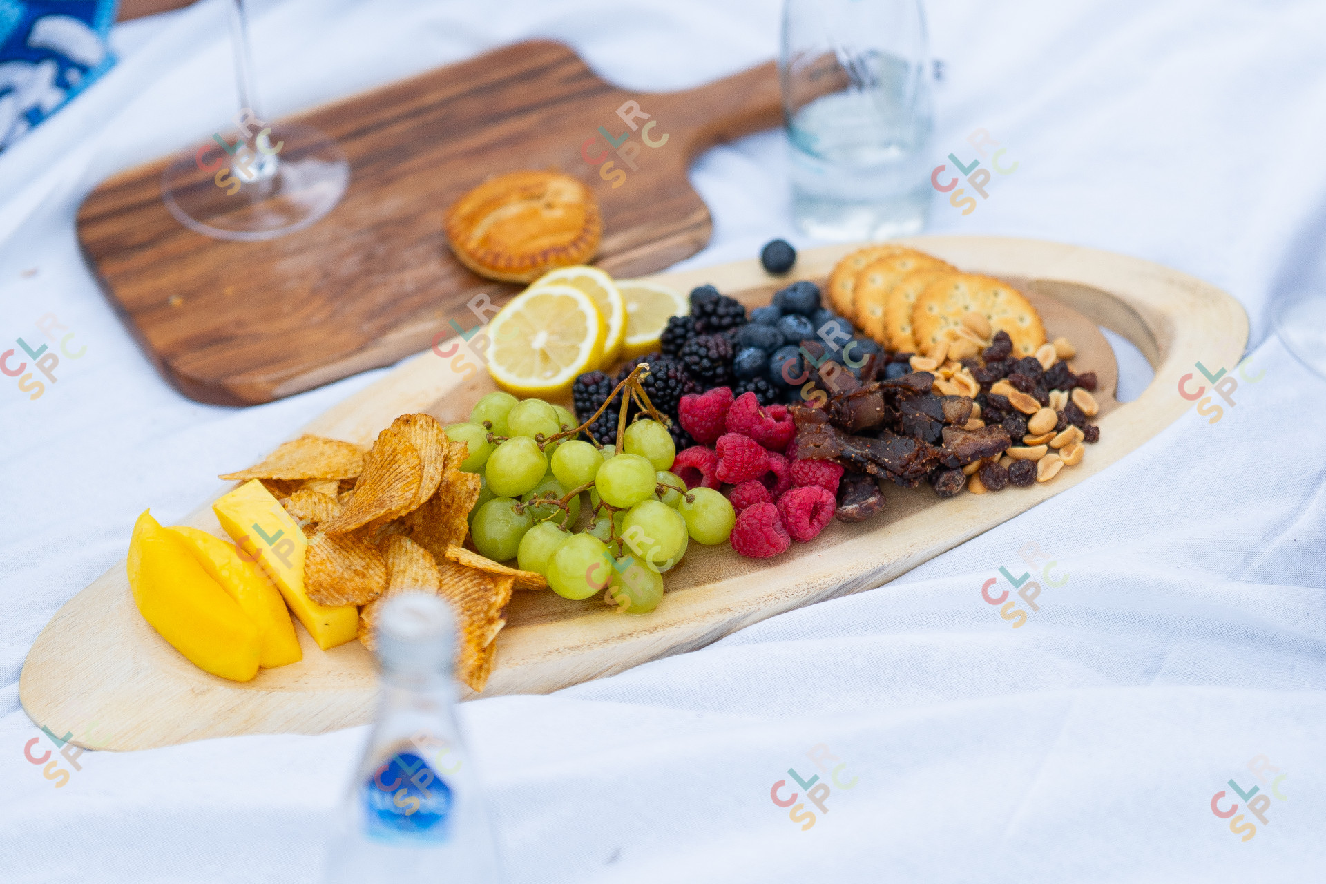 Picnic snacks on a tray with a white cloth