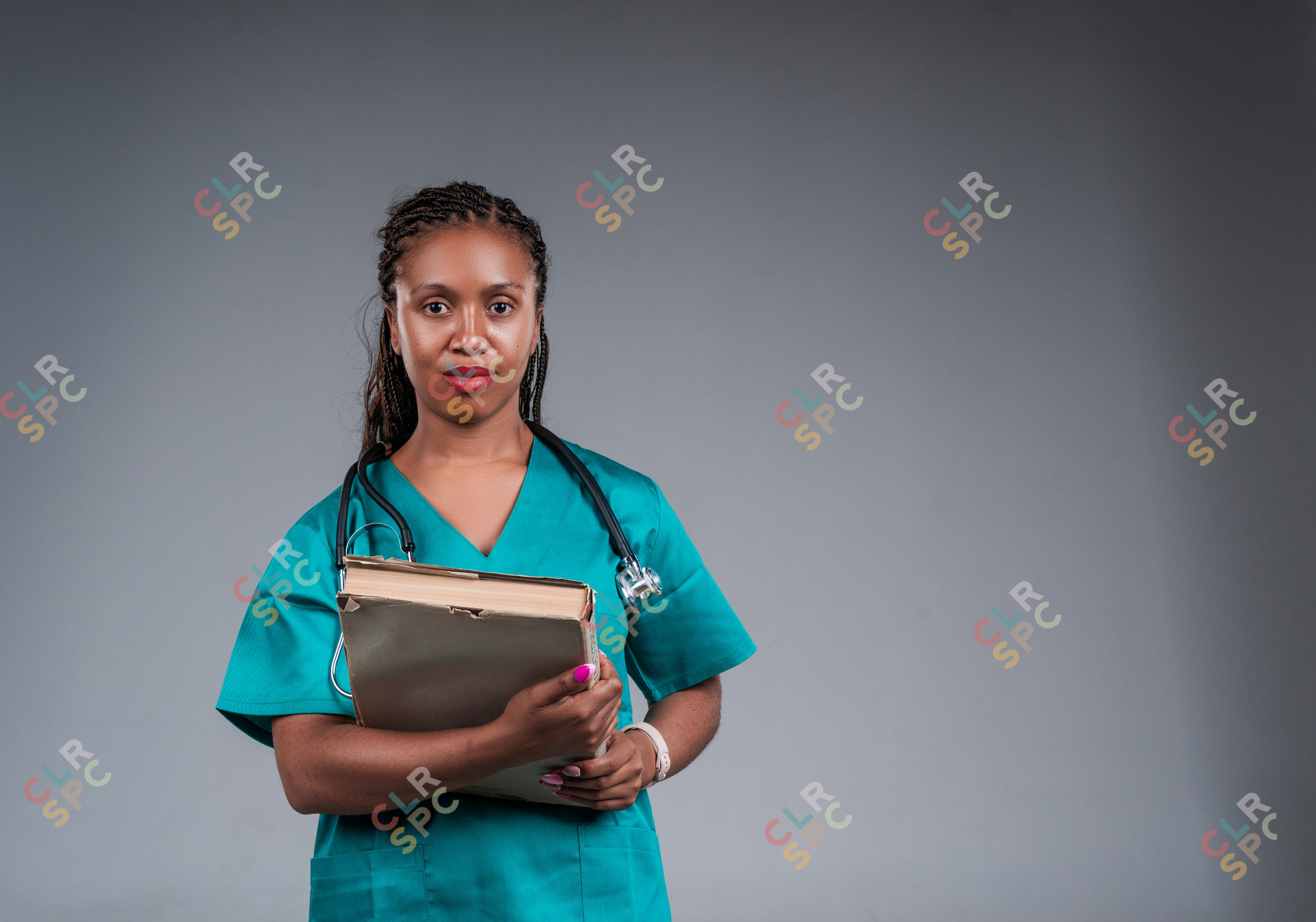 African doctor with a stethoscope, holding a book in her hands