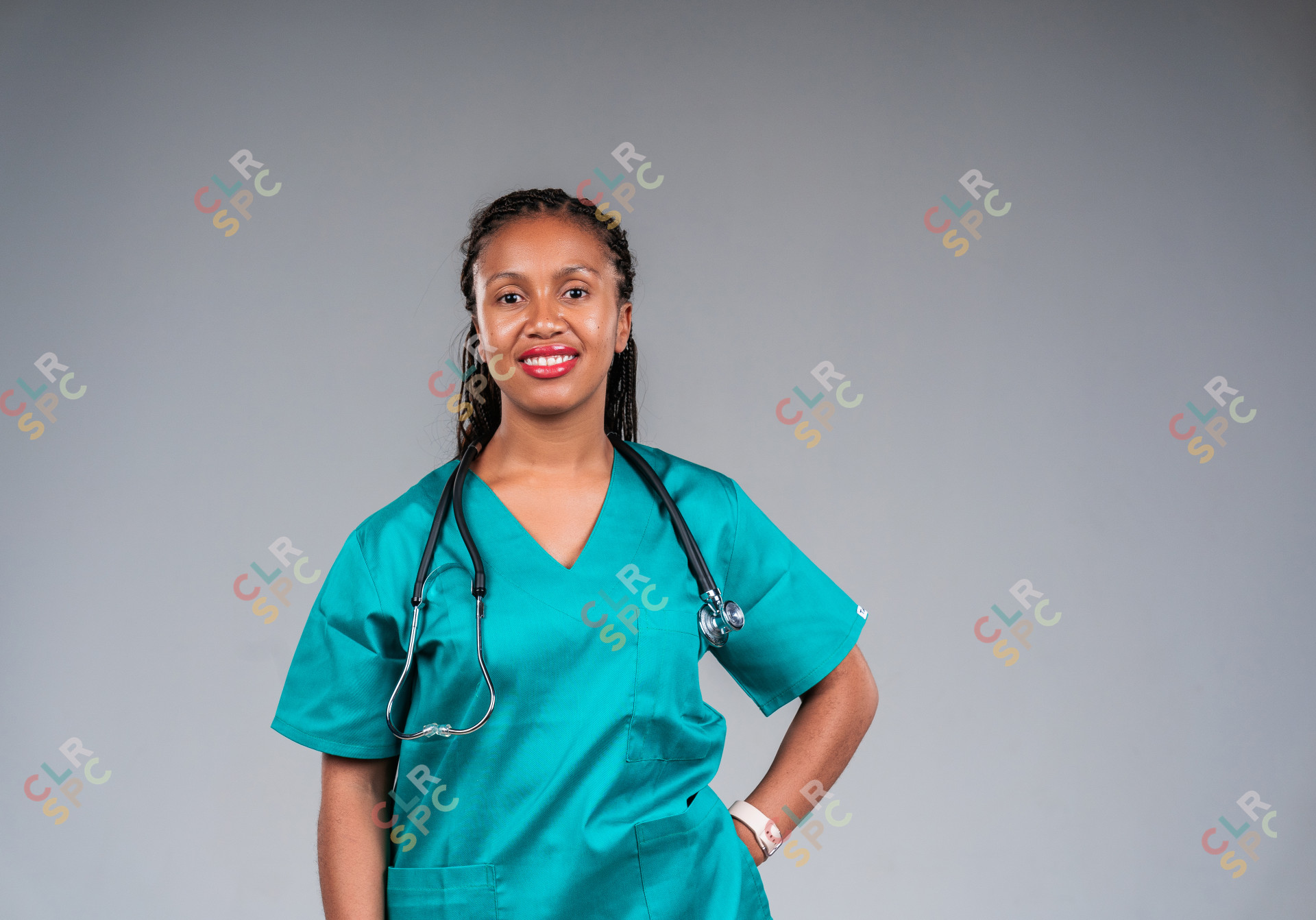 Young female doctor wearing stethoscope smiling at camera.