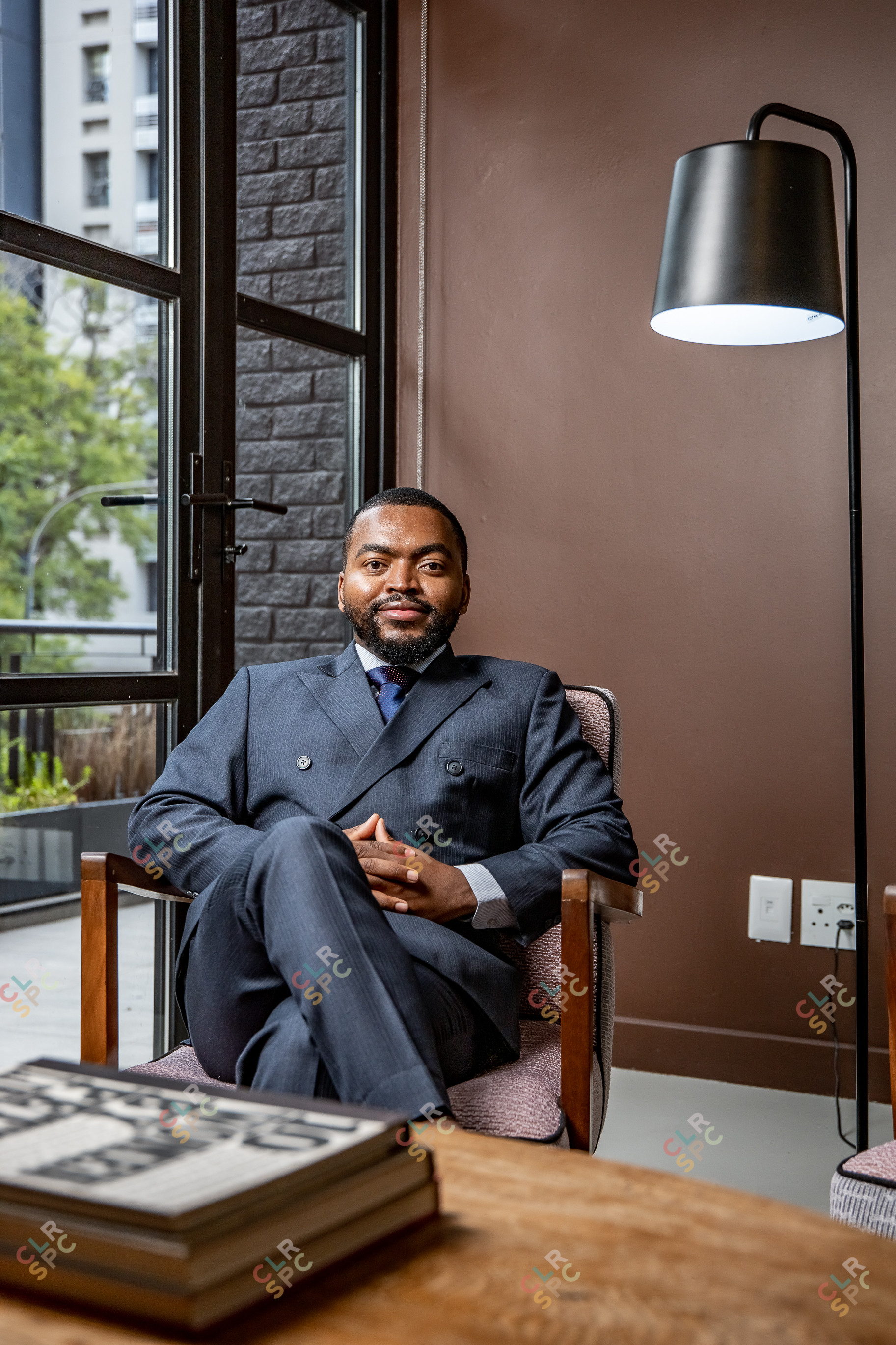 Portrait of corporate man sitting on chair smiling
