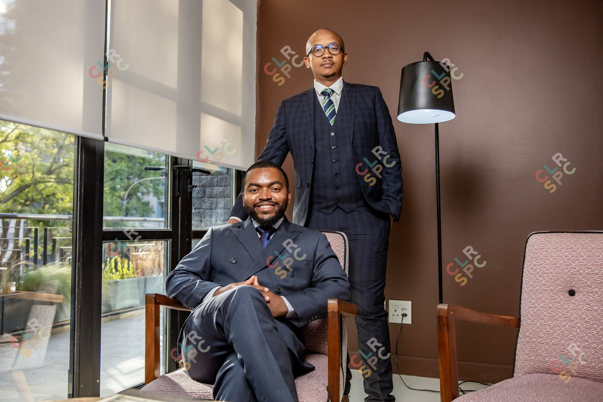 Two businessmen posing for a portrait in the office