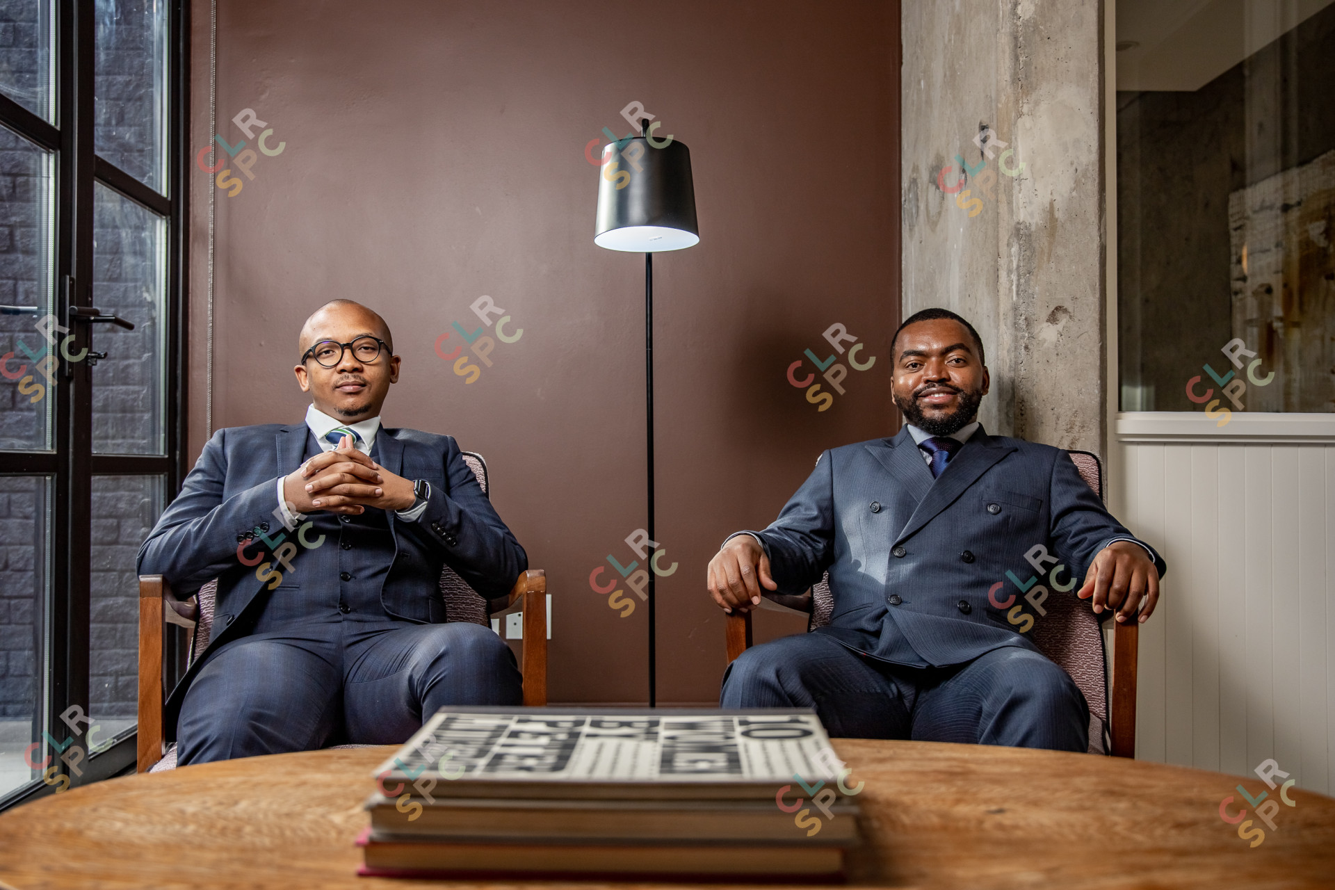 Business men sitting in the office smiling
