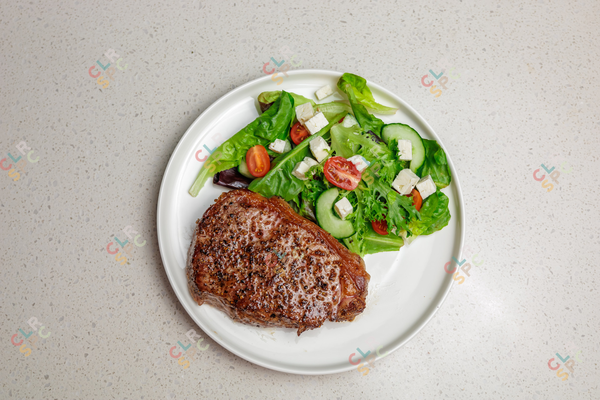 Beef steak and a classic salad with tomatoes