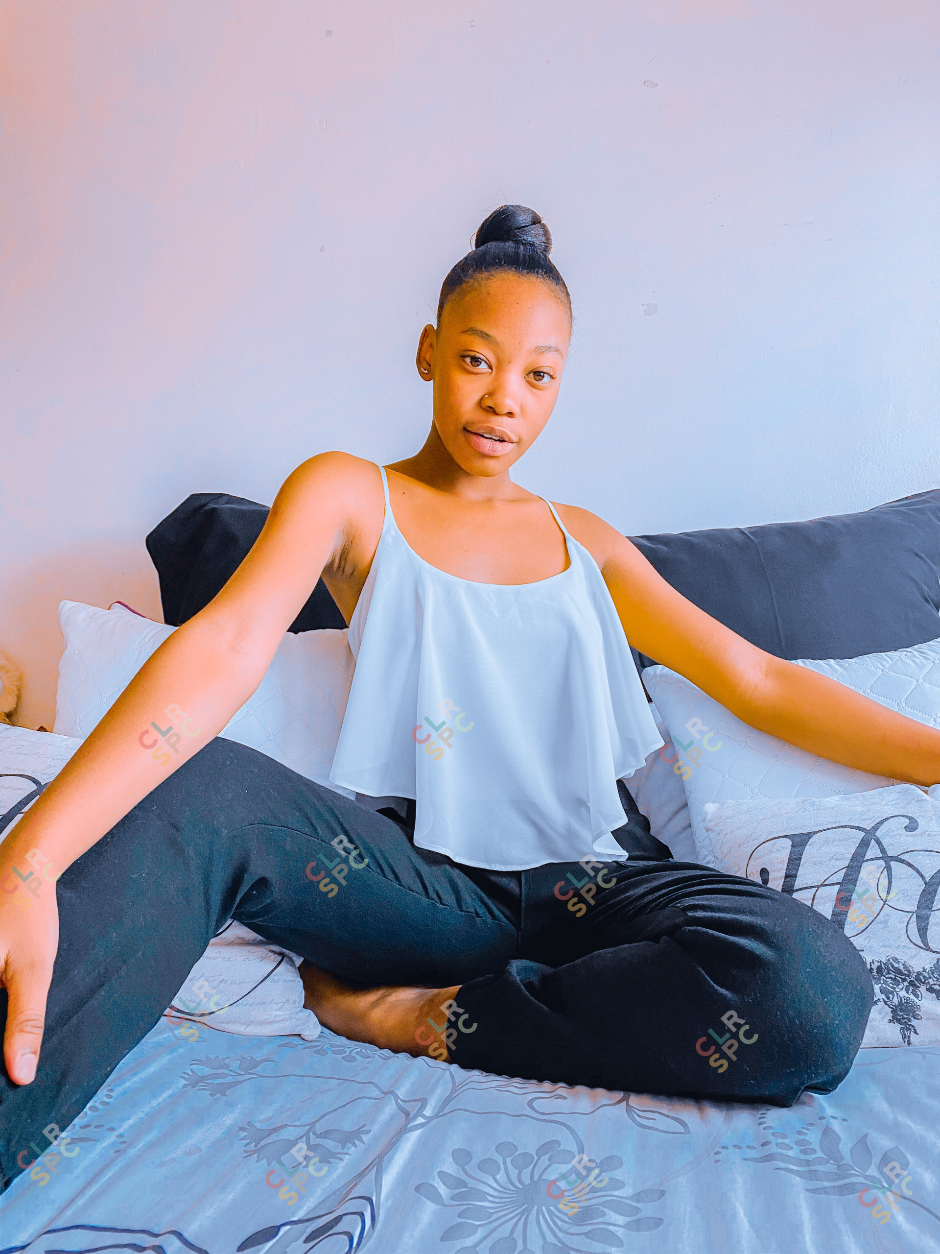 Black girl sitting on the bed