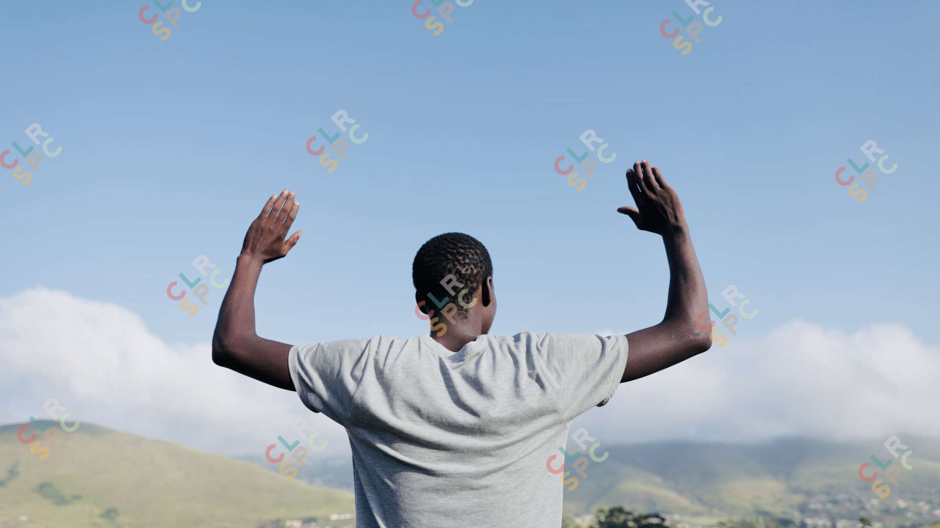 Black man praying in the mountains