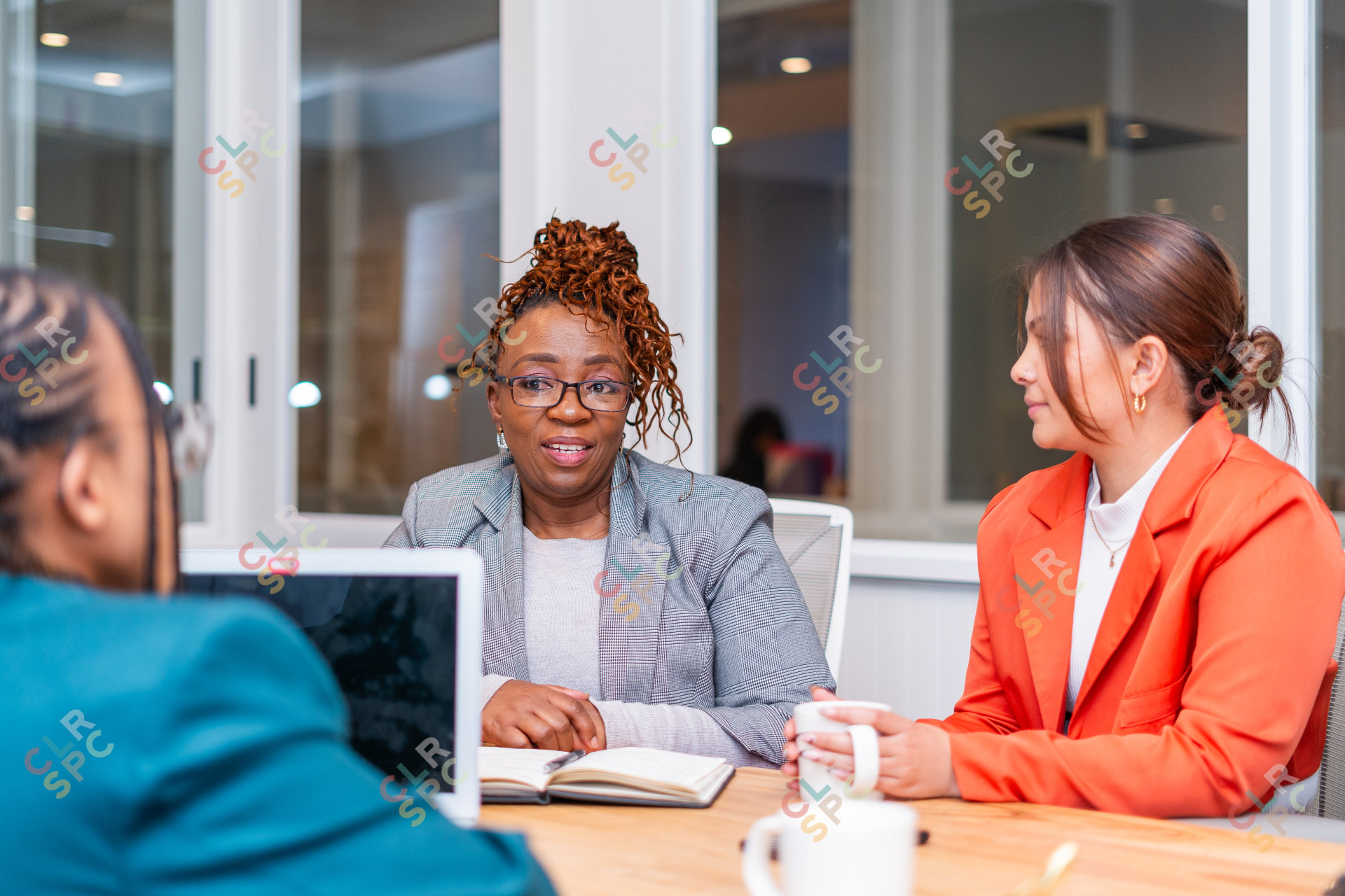 Candidate speaking to mature African black woman at an office for a job interview.